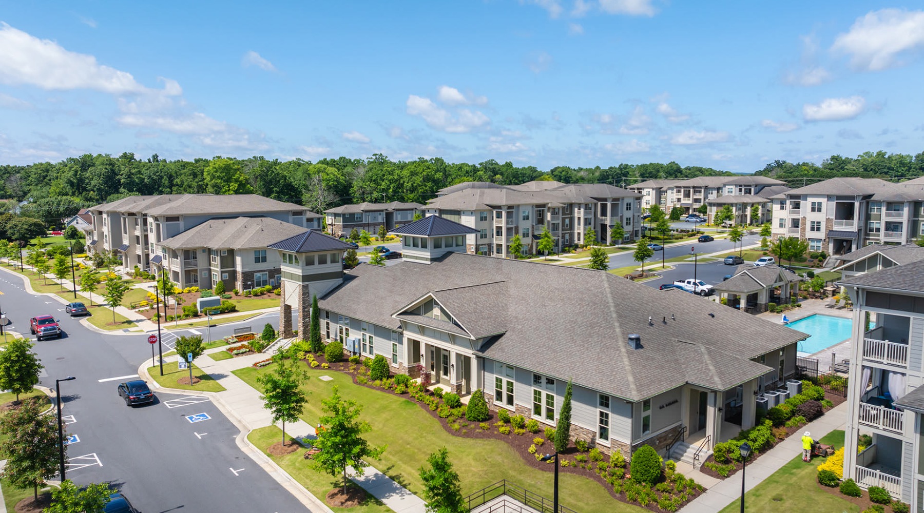 Aerial View of Pringle Square Aerial view of a modern apartment community with landscaped grounds, clubhouse, and multiple residential buildings.