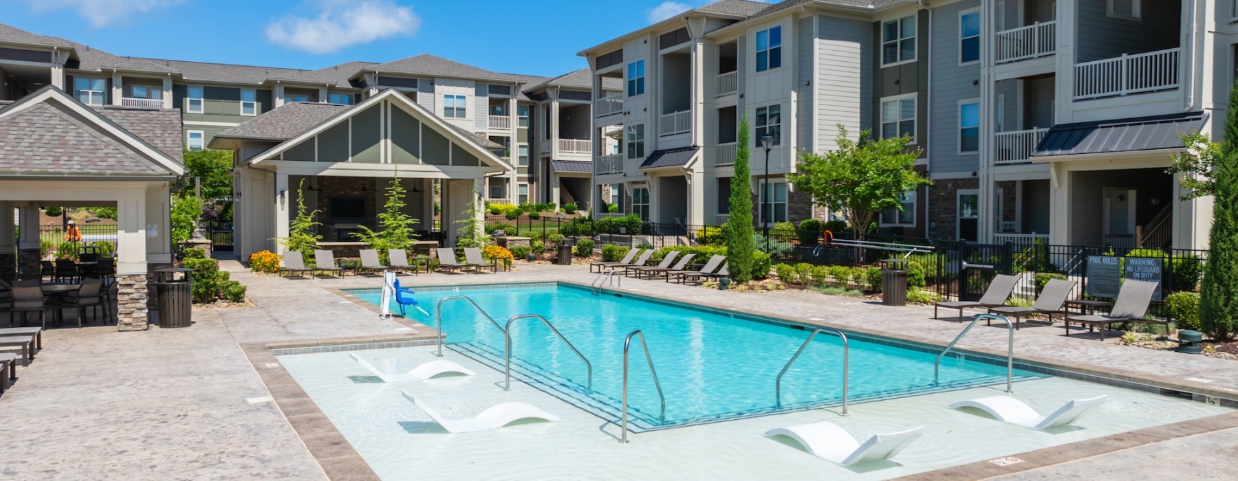 Resort-style swimming pool with lounge seating