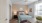 Bedroom with large window, ceiling fan, and modern decor