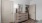 Bedroom corner with dresser, lamp, and mirror.