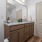 Bathroom with granite countertop and large mirror.