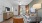 living area that includes area for a TV and bright lighting